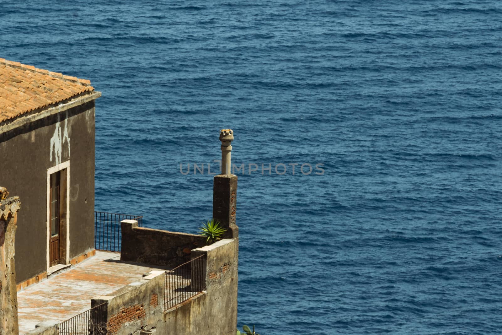 detail of an ancient Italian house over the blue sea