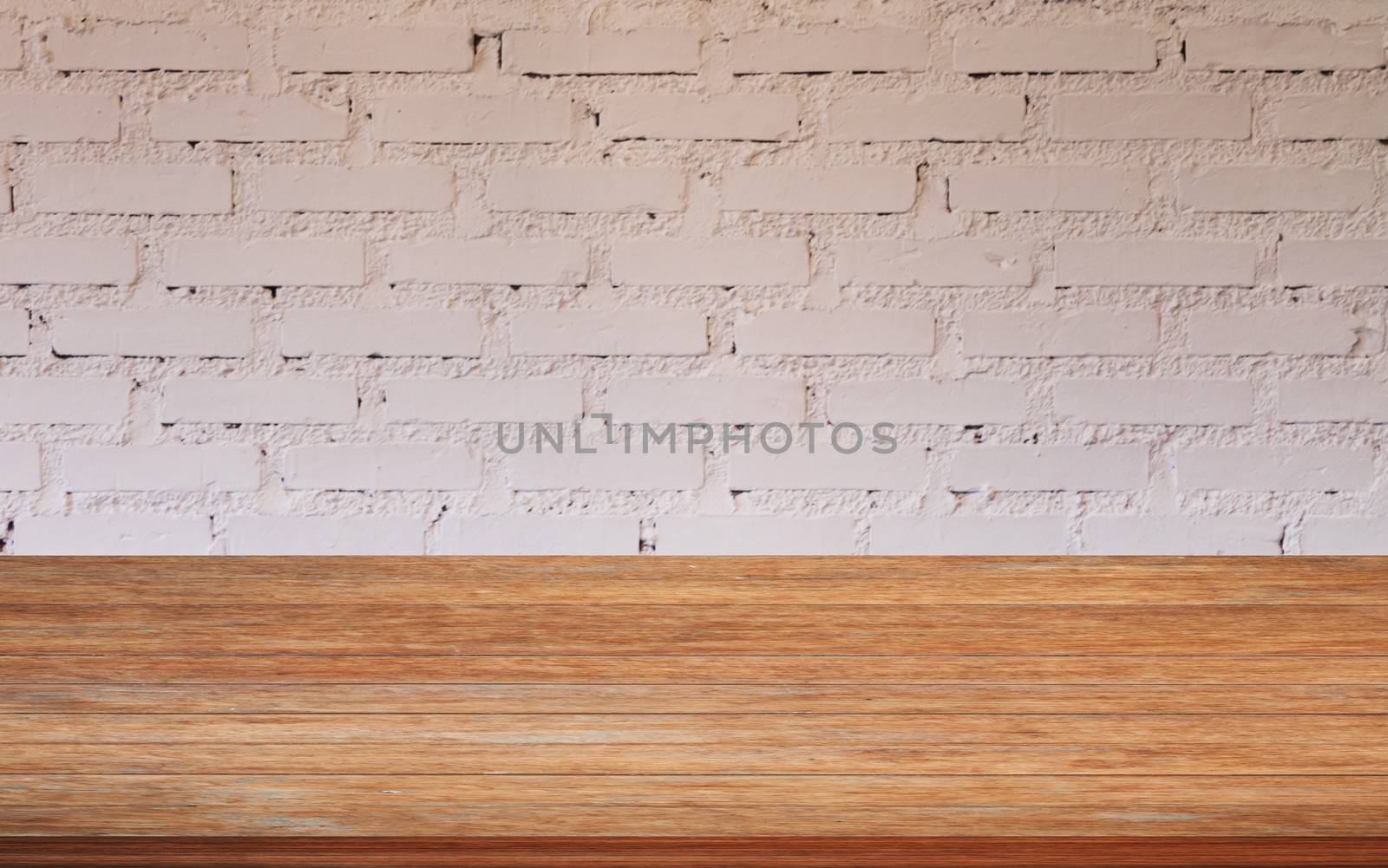 Top of wooden table with white brick wall decorated in coffee shop