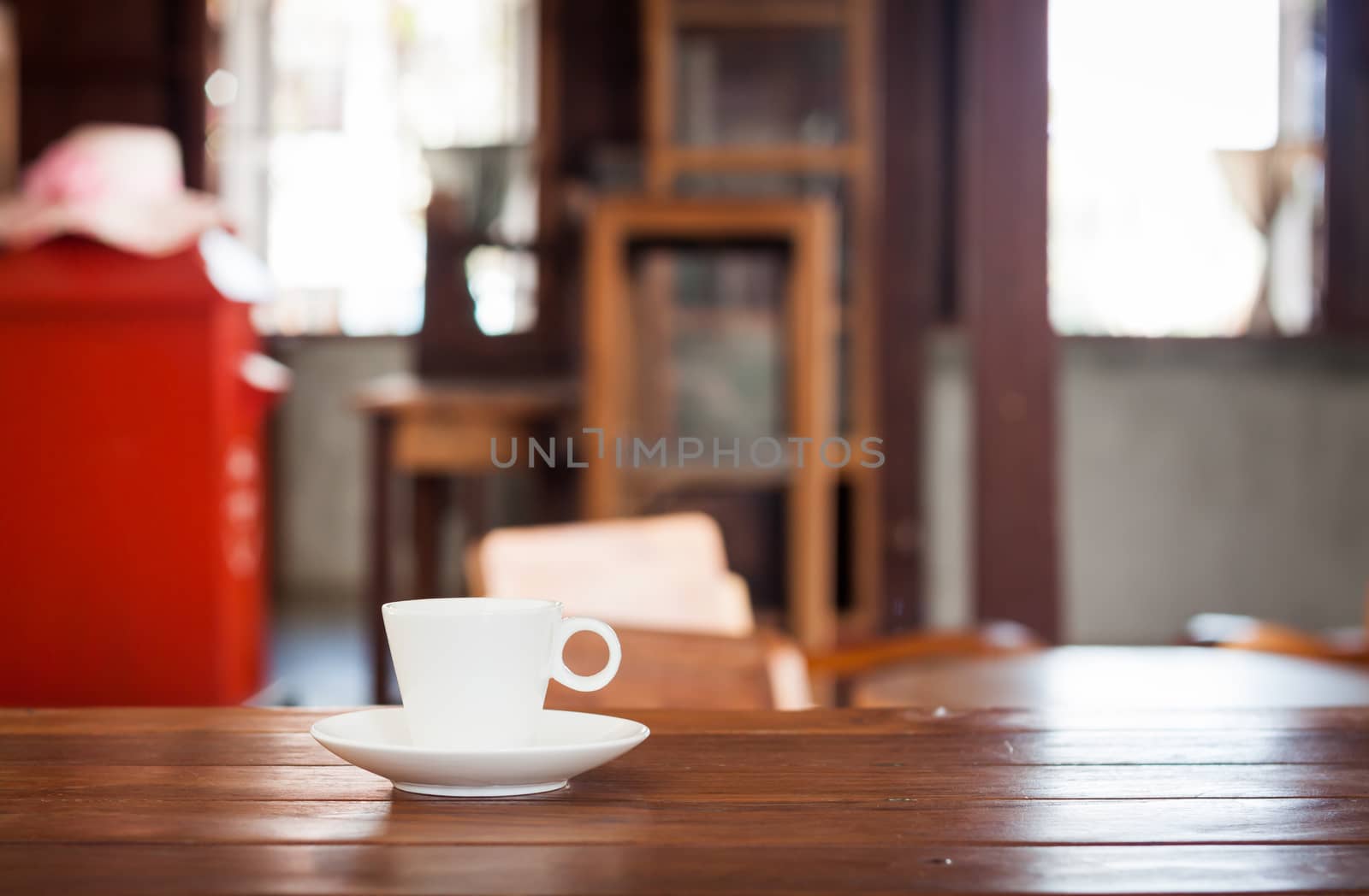 White coffee cup on wooden table in coffee shop