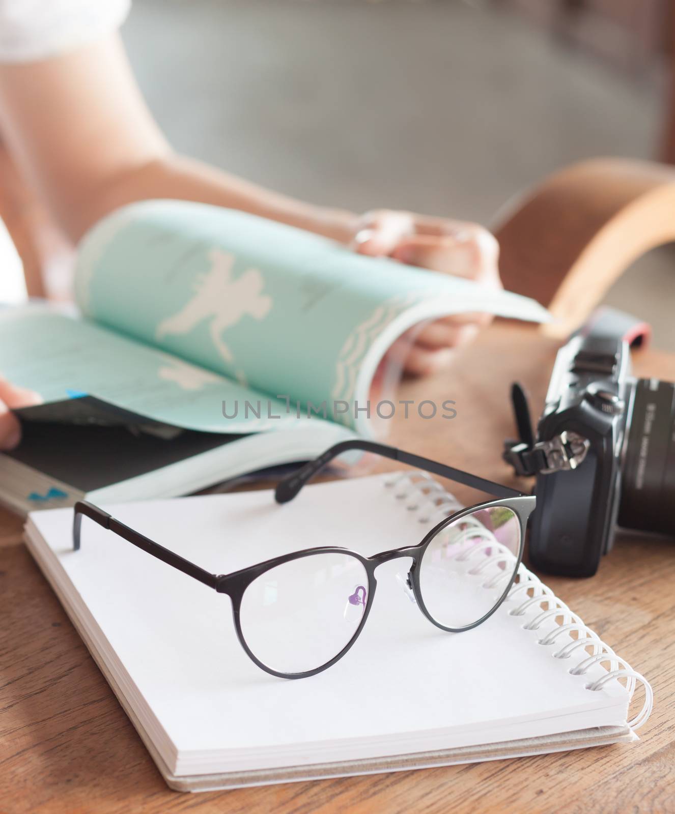 Woman reading book in coffee shop, stock photo