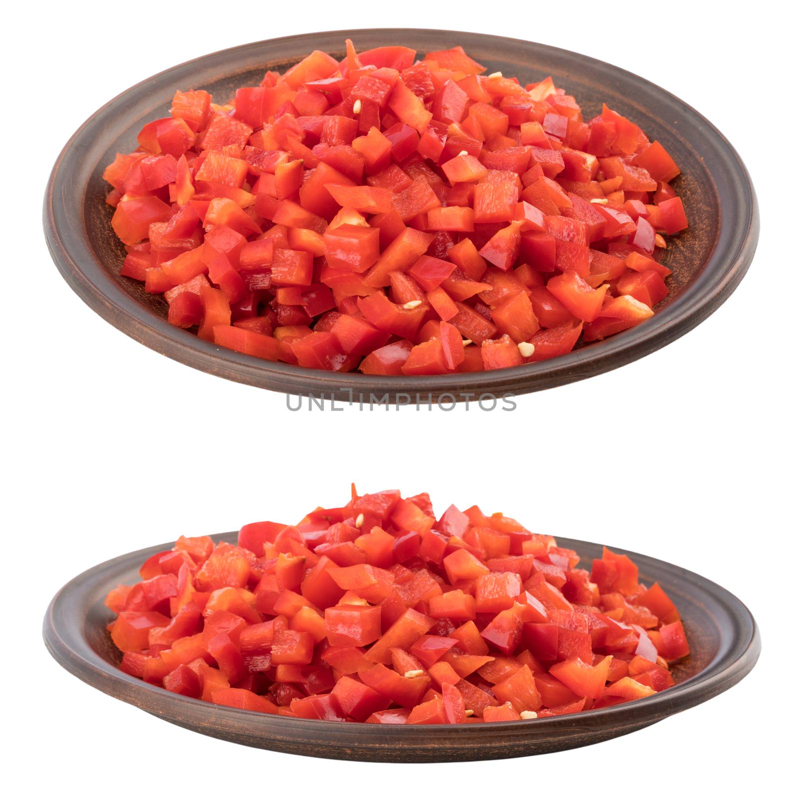 Sliced red pepper in a brown ceramic plate. Isolated on white background. 
Selective focus.