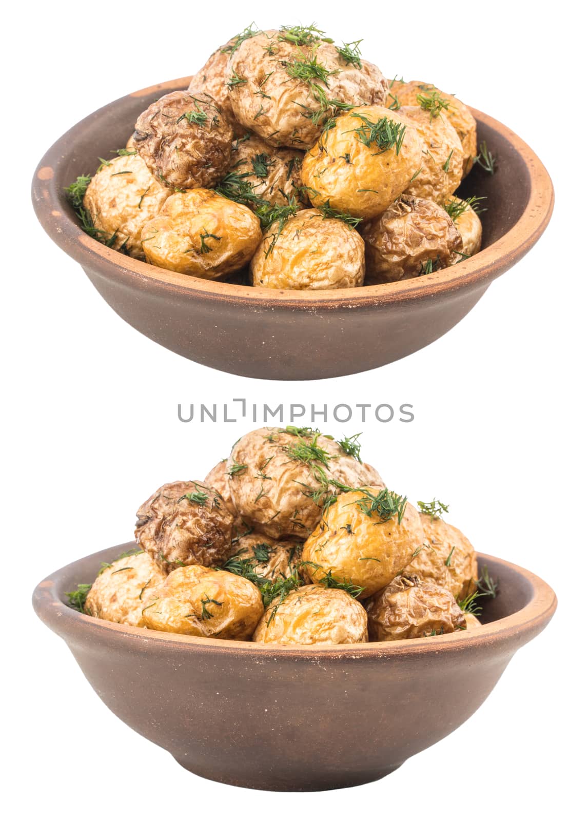Baked potatoes with spices in an old clay bowl. Selective focus.
