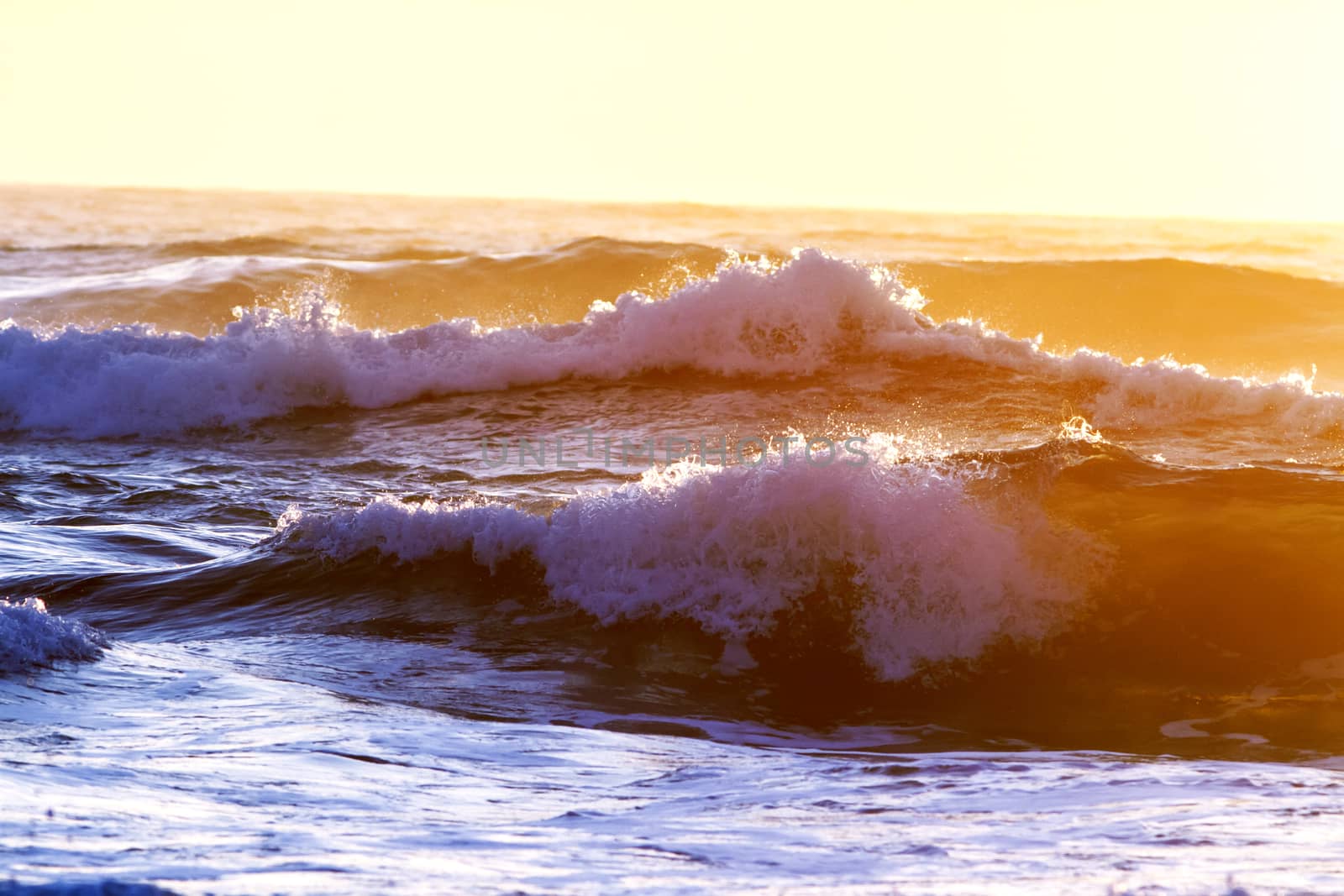 Colorful ocean waves at sunset in Chile