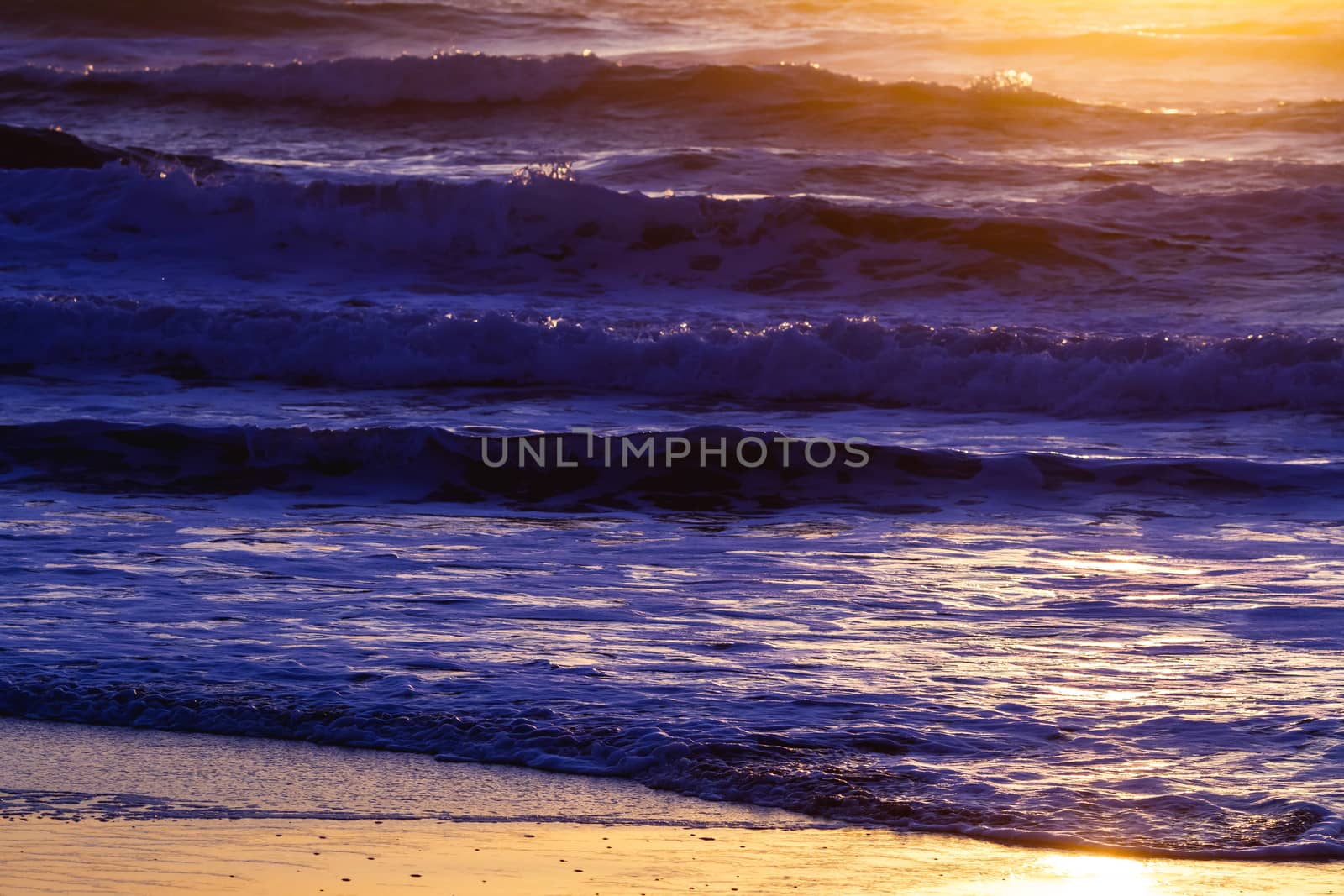 Colorful ocean waves at sunset in Chile