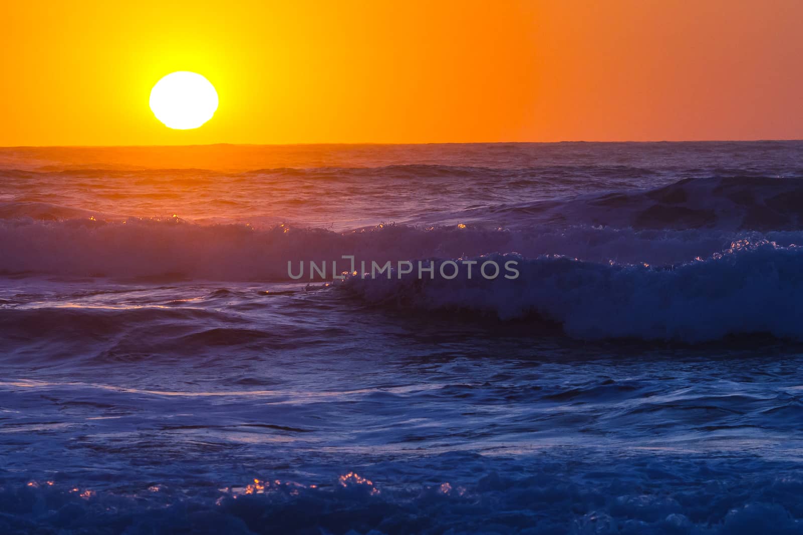 Colorful ocean waves at sunset in Chile