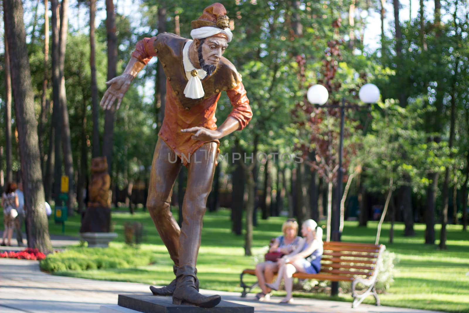 Wooden statue of Joker in city park