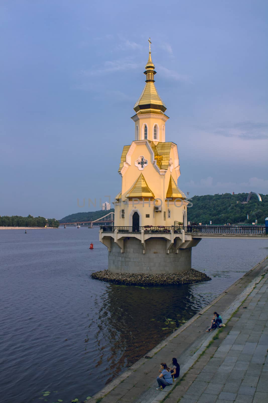 Christian Ortodox chapel on river island in Kiev in sunset