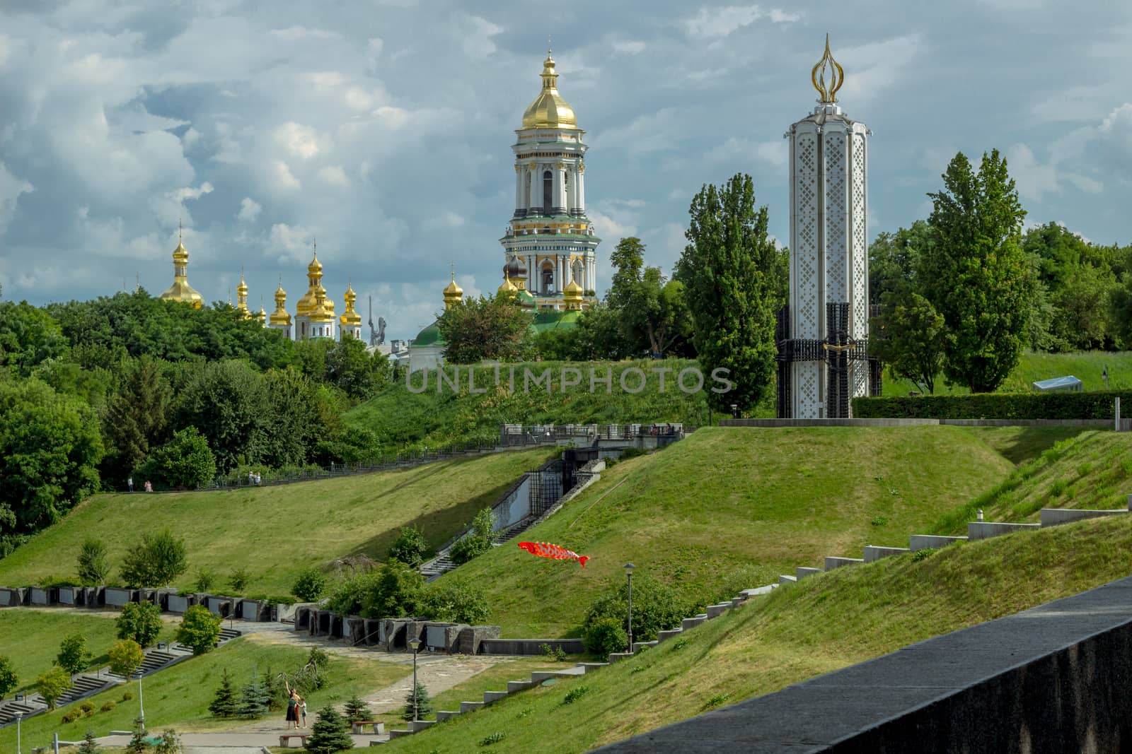 Glory park in Kiev on green hills with famine memorial and orthodox monastery
