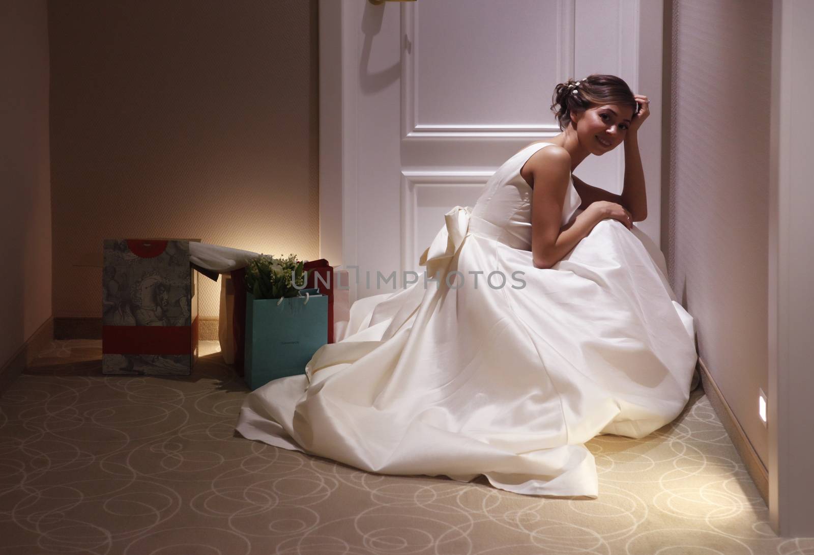 The beautiful bride with bouquet in room