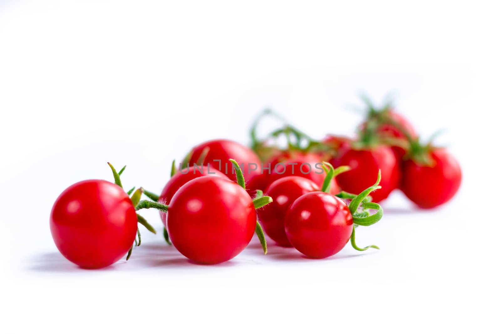 Cluster of cherry tomatoes on white background