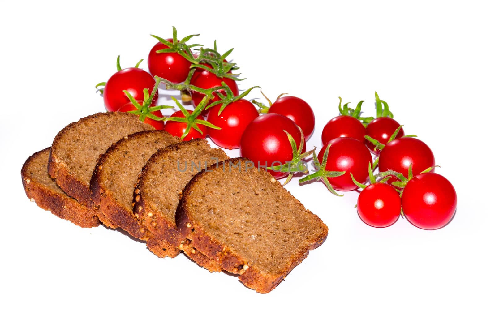 Composition of black bread slices and cherry tomatoes