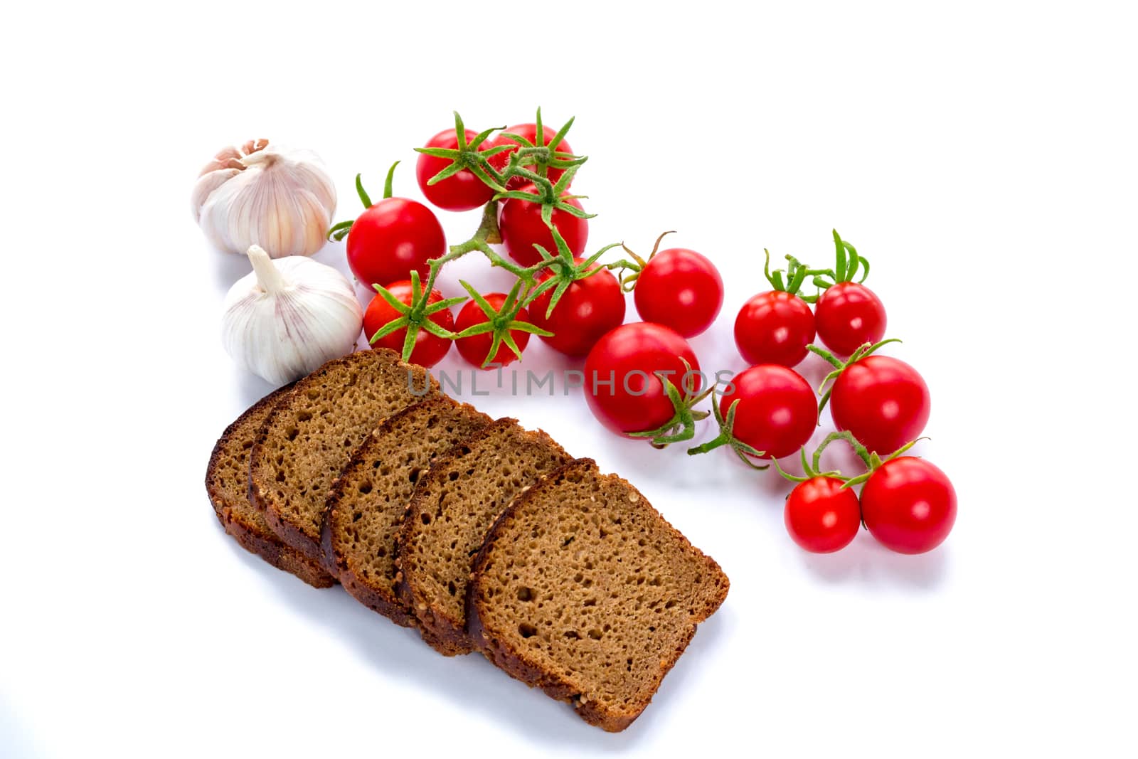 Set of black bread slices, cherry tomatoes and garlic