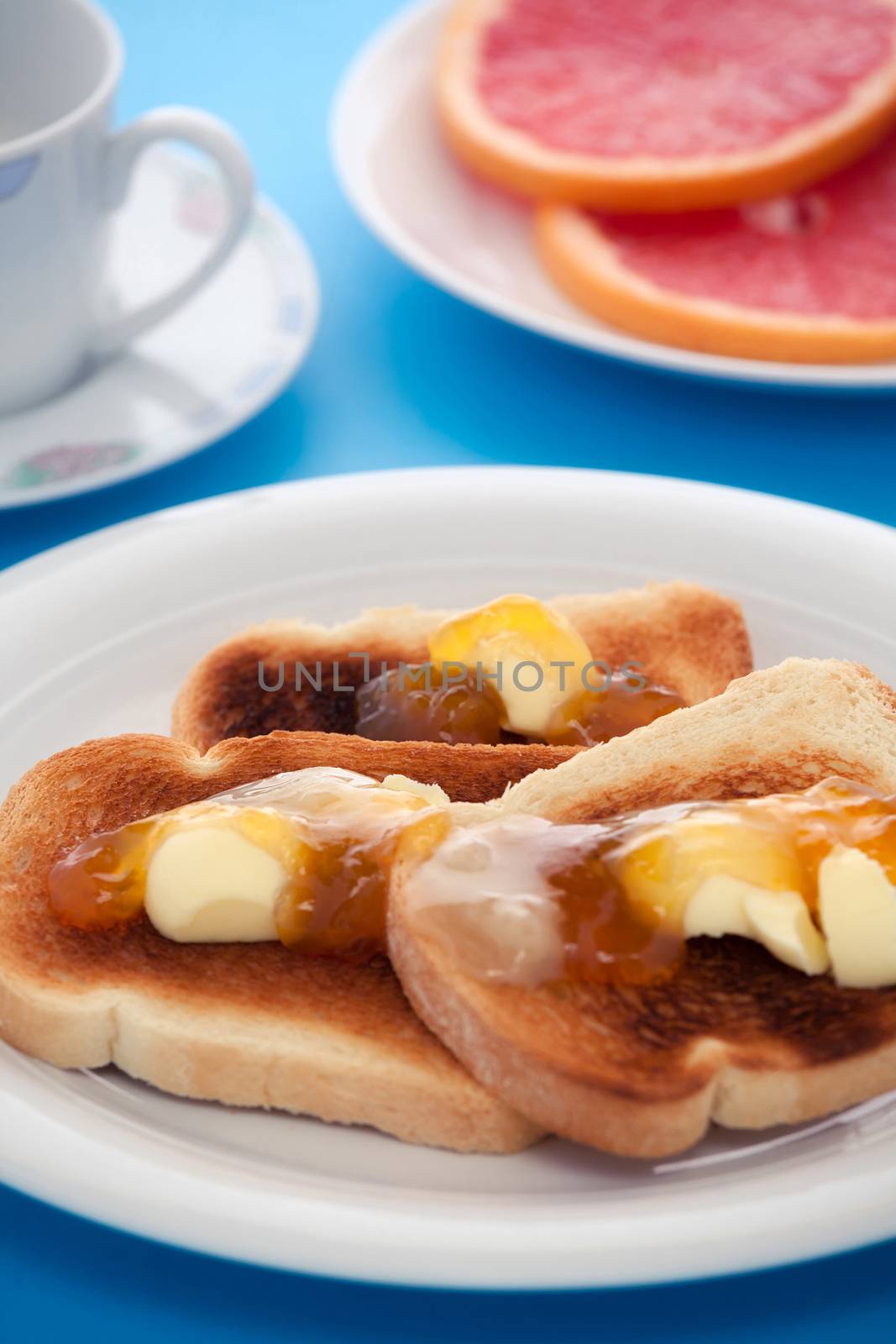 French toast and sliced orange fruit on blue tablecloth