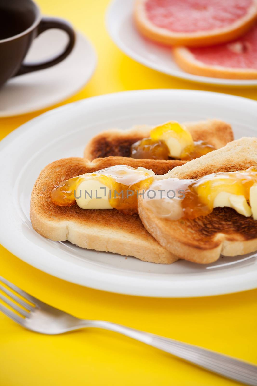 French toast with sliced orange fruit on yellow tablecloth by LuigiMorbidelli