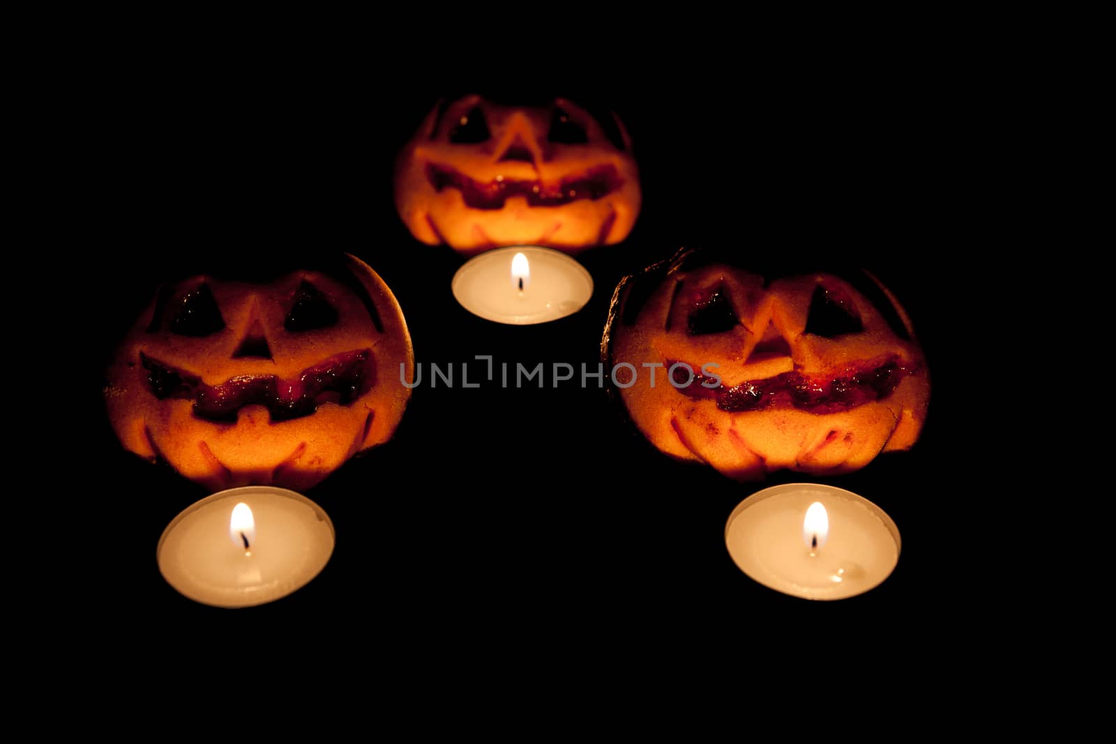 Three pumpkins with three candles