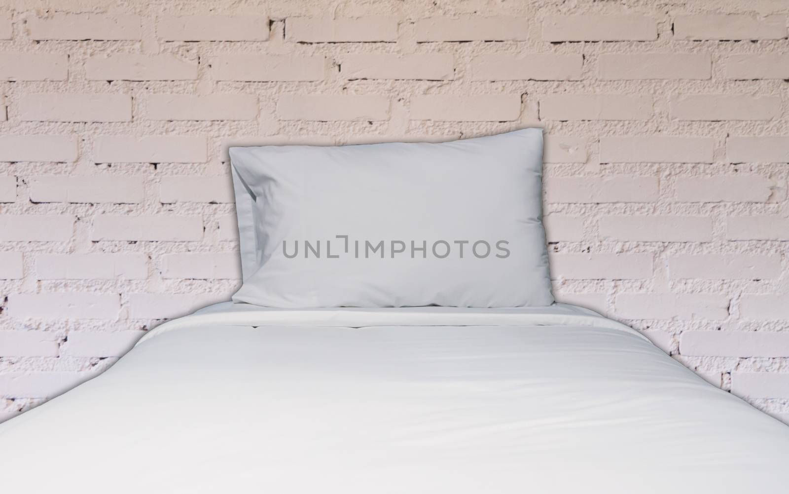 Single bed with white brick wall decorated in coffee shop