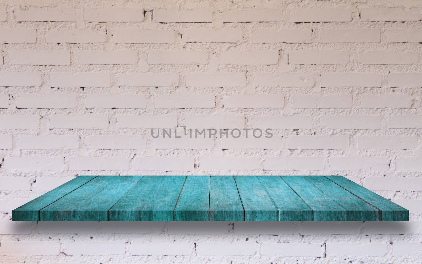 Top of blue wooden shelf with white brick wall decorated in coffee shop
