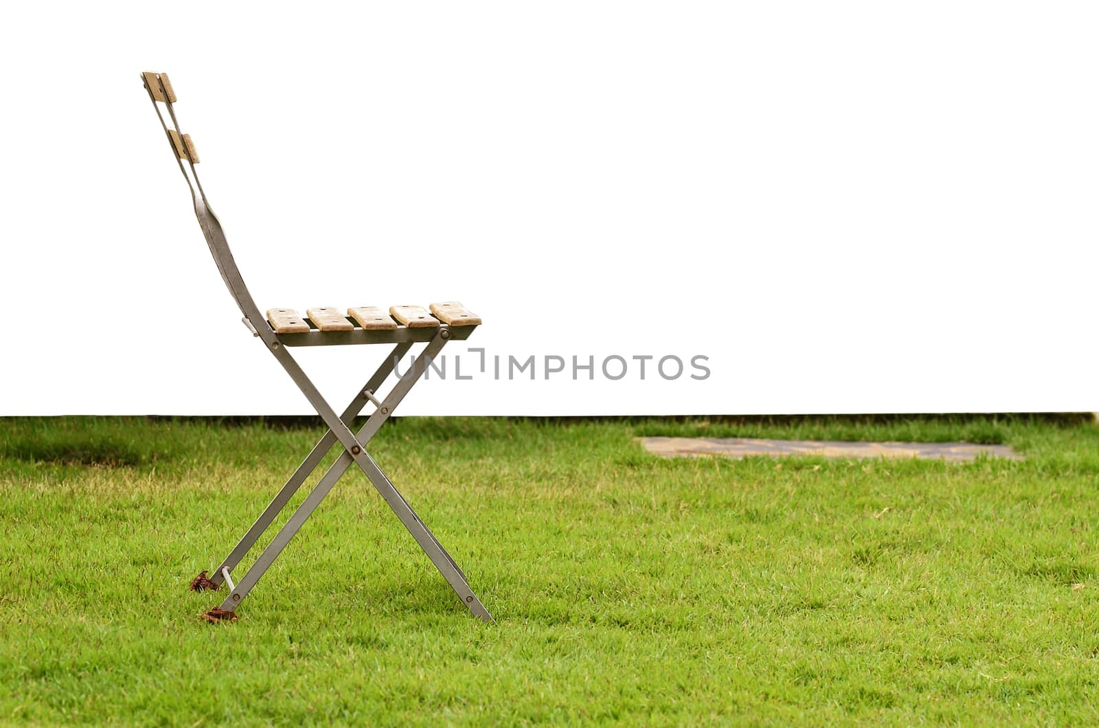 Old chair on green grass by raweenuttapong