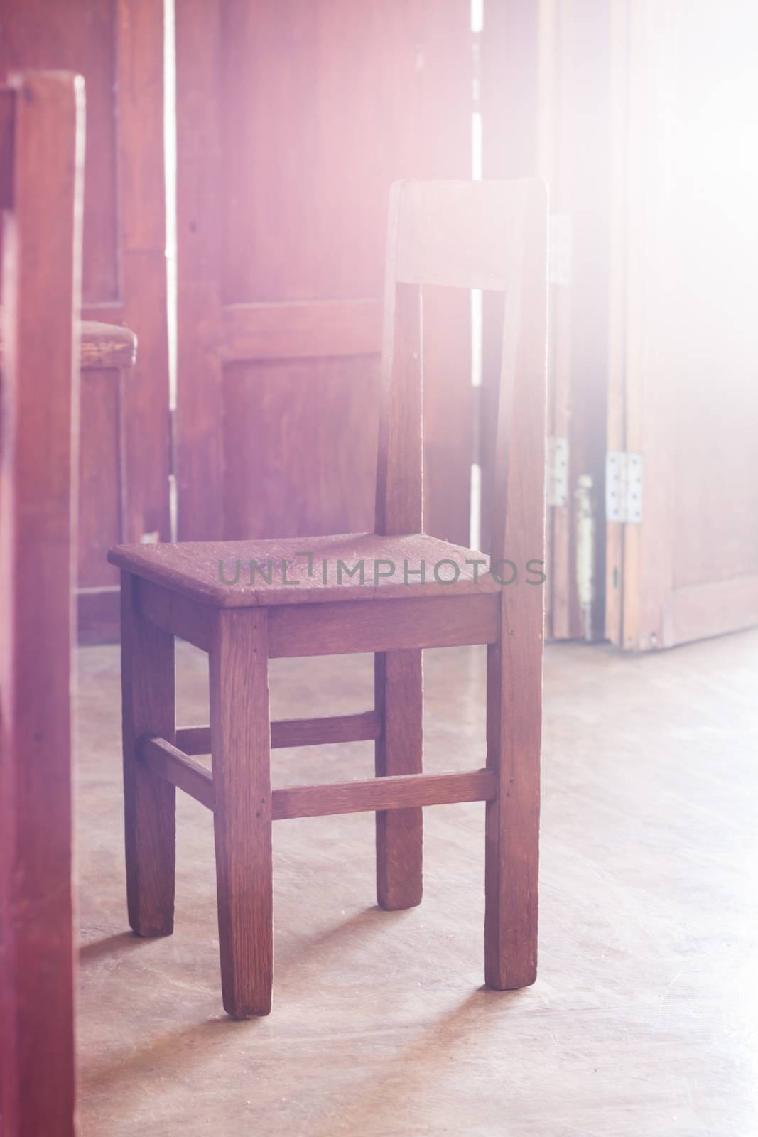 Old style wooden chair in coffee shop with vintage filter, stock photo