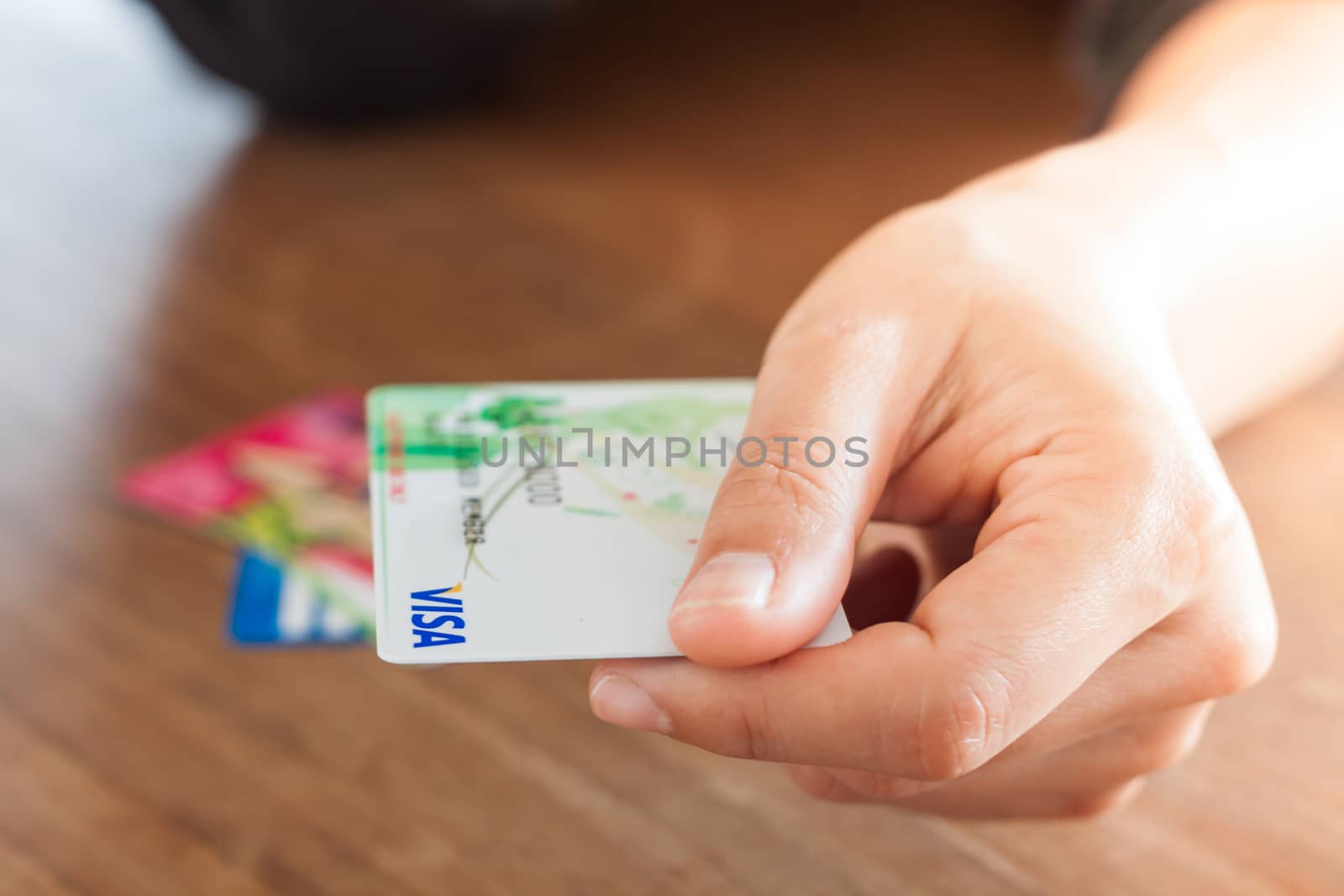 CHIANG RAI, THAILAND - March 3, 2016: Woman's hand holding visa card, stock photo