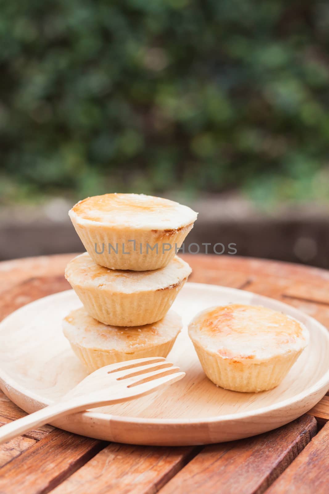 Mini pies on wooden plate, stock photo