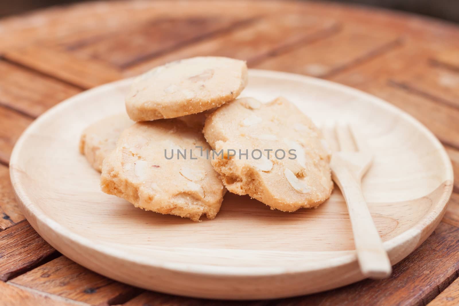 Cashew cookies on wooden plate, stock photo