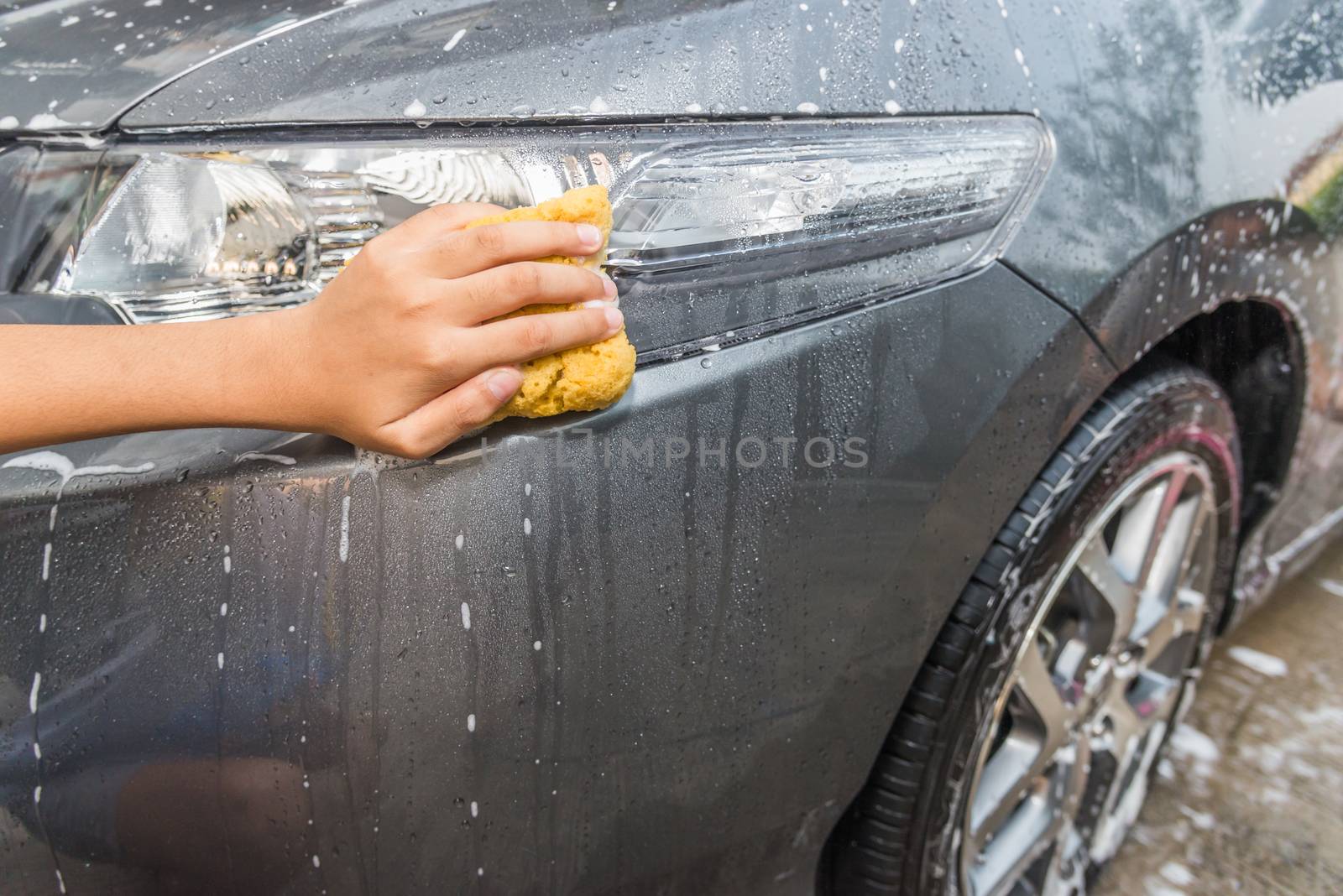 outdoor car wash with yellow sponge
