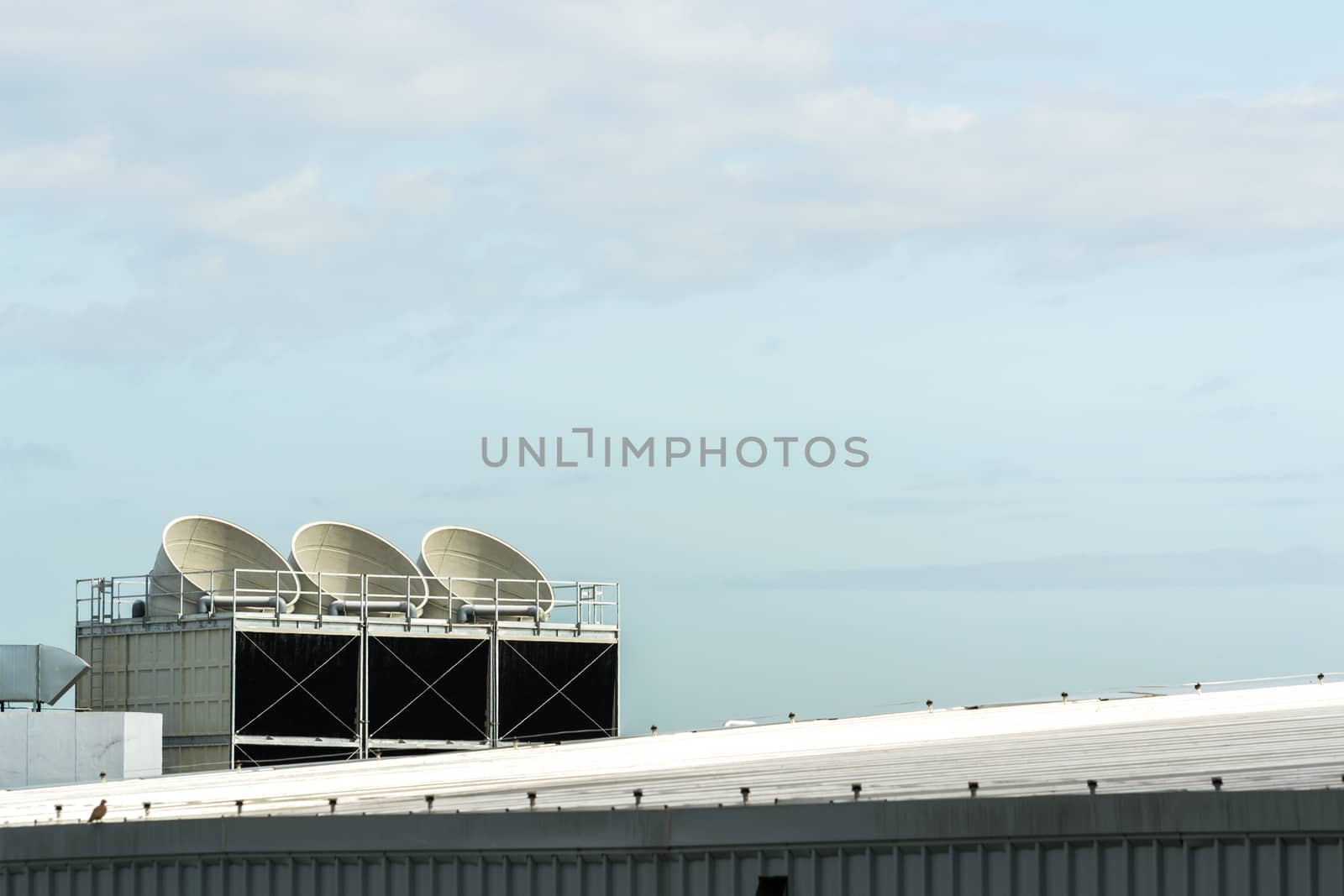 Communication Satellite dish on the roof on a building.