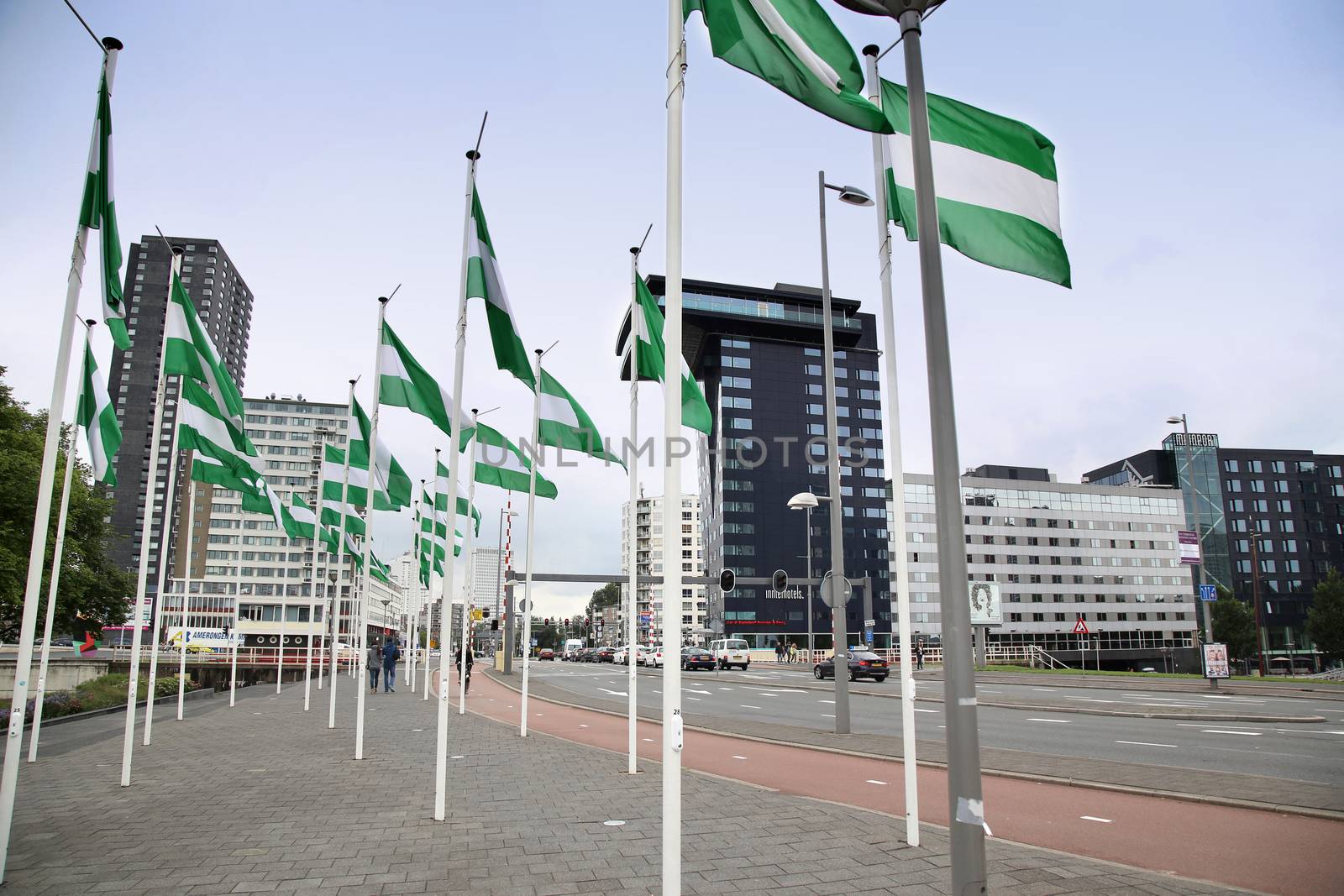 ROTTERDAM, THE NETHERLANDS - 18 AUGUST: Rotterdam is a city modern architecture, Nieuwe Leuvebrug street with green-white-green flags of Rotterdam in Rotterdam, Netherlands on August 18,2015.