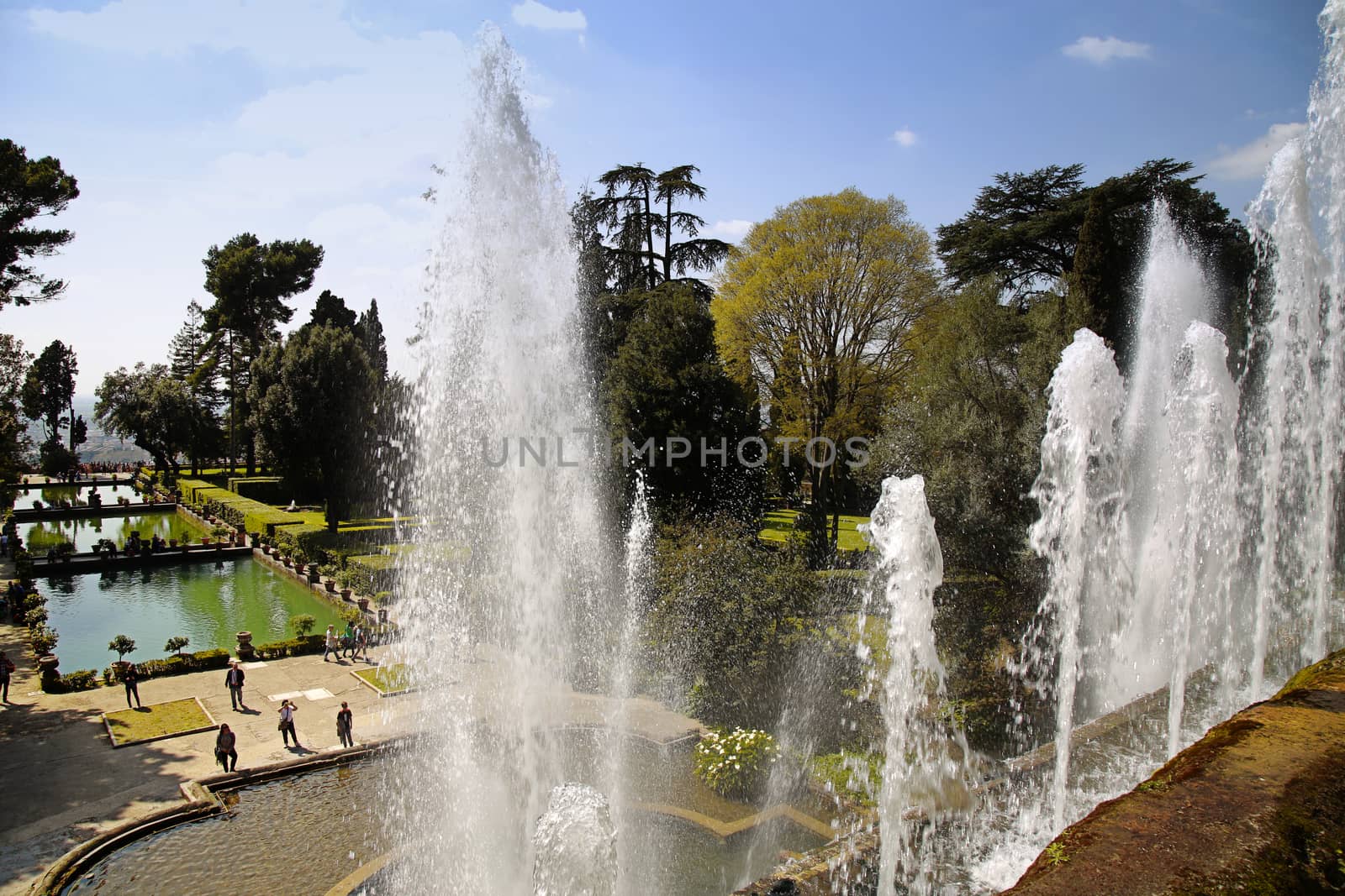 TIVOLI, ITALY - APRIL 10, 2015: Tourists visiting Fountain of Neptune and Organ in Villa d'Este in Tivoli. Villa d`Este fountain and garden in Tivoli near Roma, Italy on April 10, 2015.