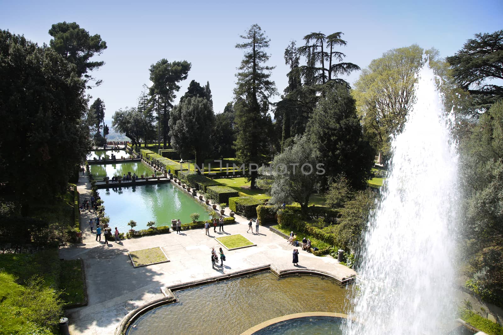 TIVOLI, ITALY - APRIL 10, 2015: Tourists visiting Fountain of Neptune and Organ in Villa d'Este in Tivoli. Villa d`Este fountain and garden in Tivoli near Roma, Italy on April 10, 2015.