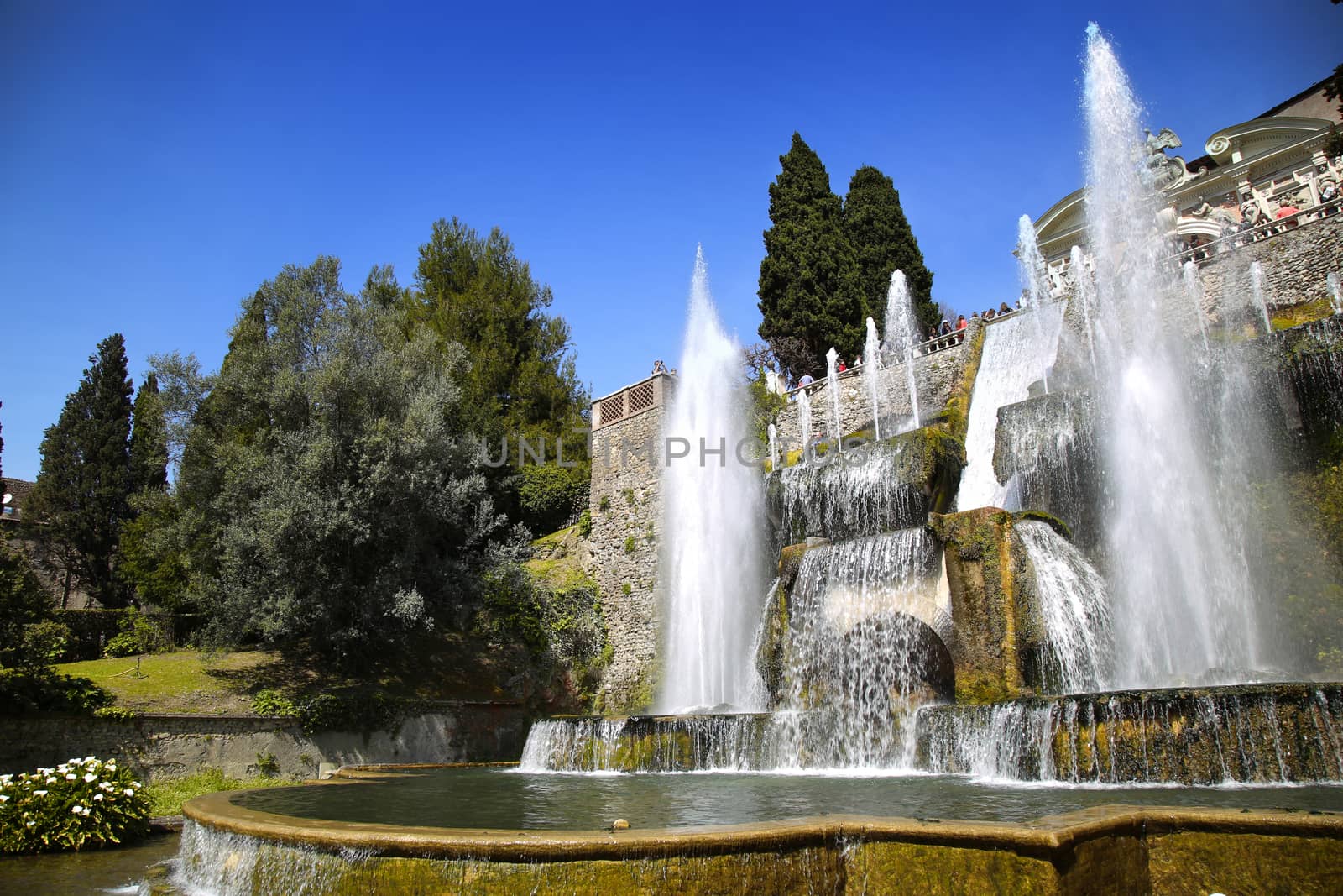 TIVOLI, ITALY - APRIL 10, 2015: Tourists visiting Fountain of Neptune and Organ in Villa d'Este in Tivoli. Villa d`Este fountain and garden in Tivoli near Roma, Italy on April 10, 2015.