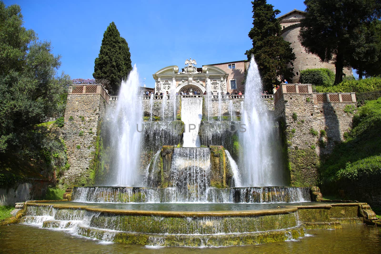 TIVOLI, ITALY - APRIL 10, 2015: Tourists visiting Fountain of Neptune and Organ in Villa d'Este in Tivoli. Villa d`Este fountain and garden in Tivoli near Roma, Italy on April 10, 2015.