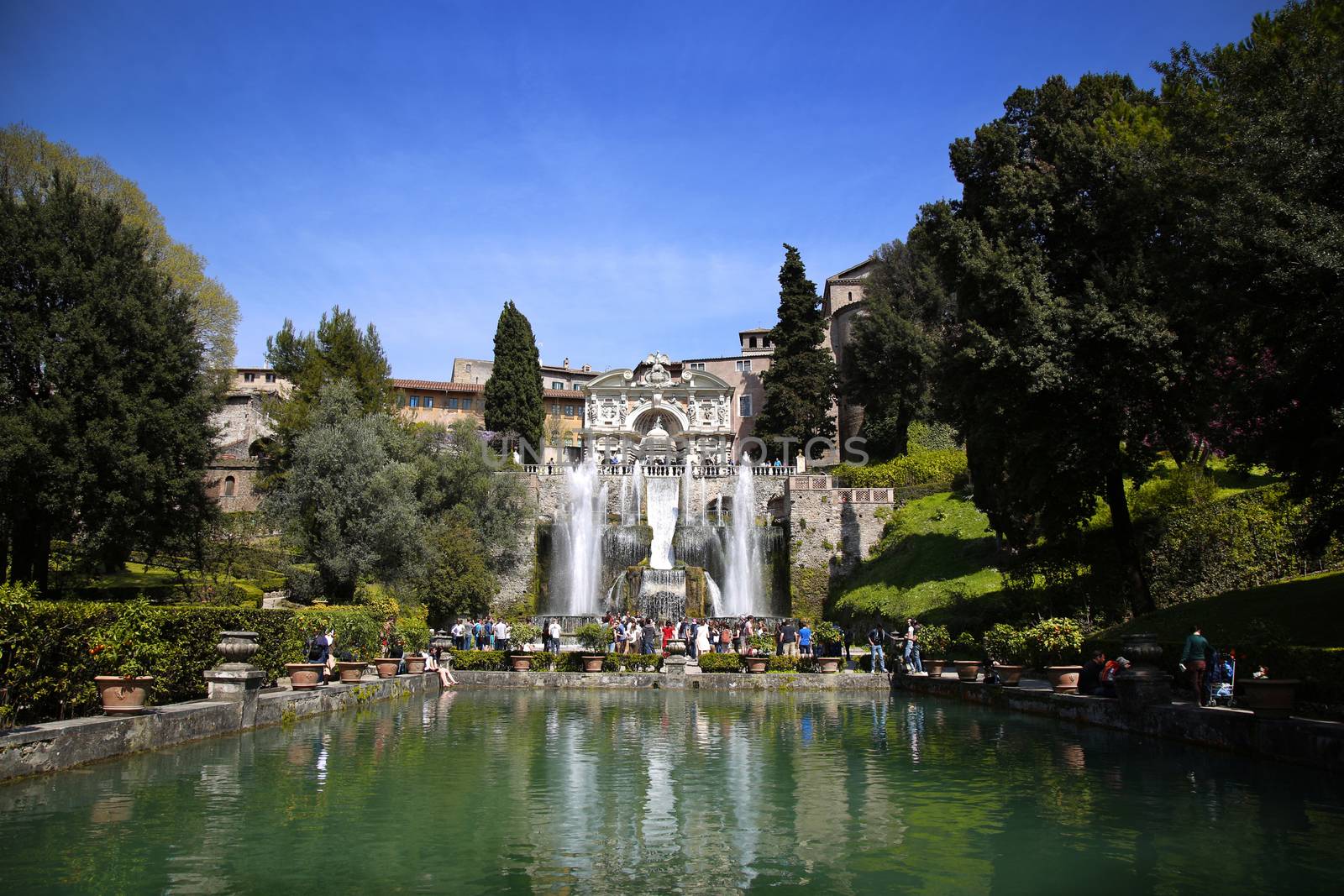 TIVOLI, ITALY - APRIL 10, 2015: Tourists visiting Fountain of Neptune and Organ in Villa d'Este in Tivoli. Villa d`Este fountain and garden in Tivoli near Roma, Italy on April 10, 2015.
