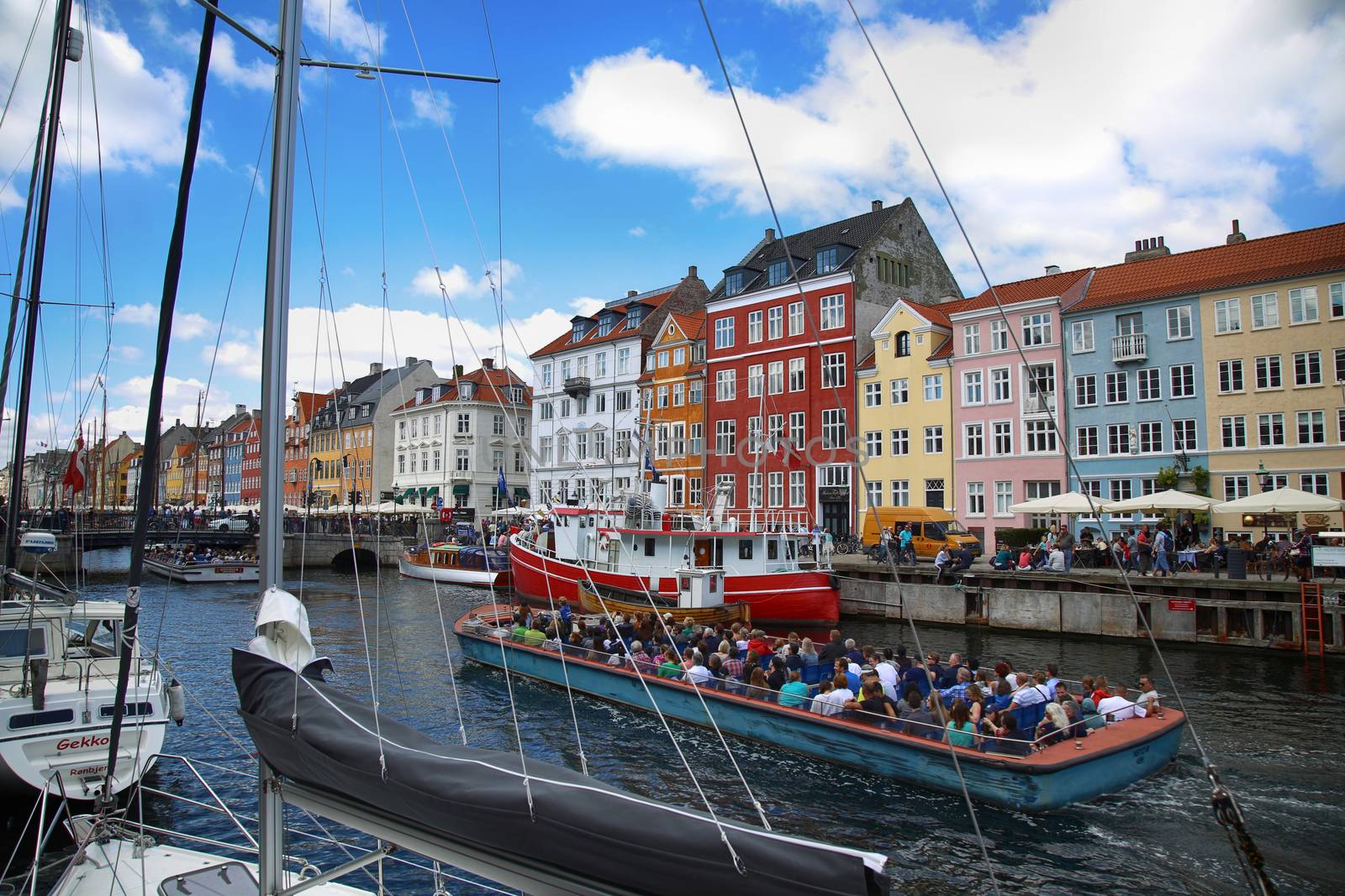 COPENHAGEN, DENMARK - AUGUST 15, 2016: Boats in the docks Nyhavn, people, restaurants and colorful architecture. Nyhavn a 17th century harbour in Copenhagen, Denmark on August 15, 2016.