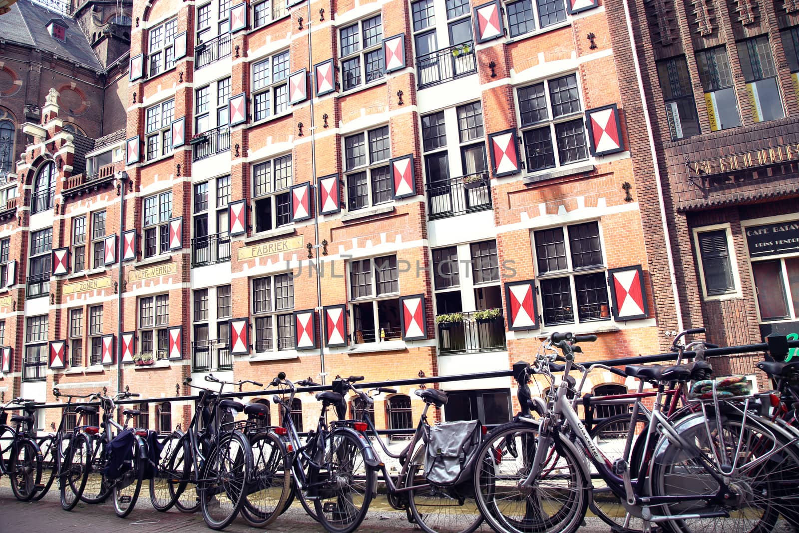 AMSTERDAM; THE NETHERLANDS - AUGUST 19; 2015: View on Oudezijds Kolk canal in Amsterdam, building Verf en Vernis Fabriek H.Vettewinke in Amsterdam. Amsterdam is capital of the Netherlands on August 19; 2015.