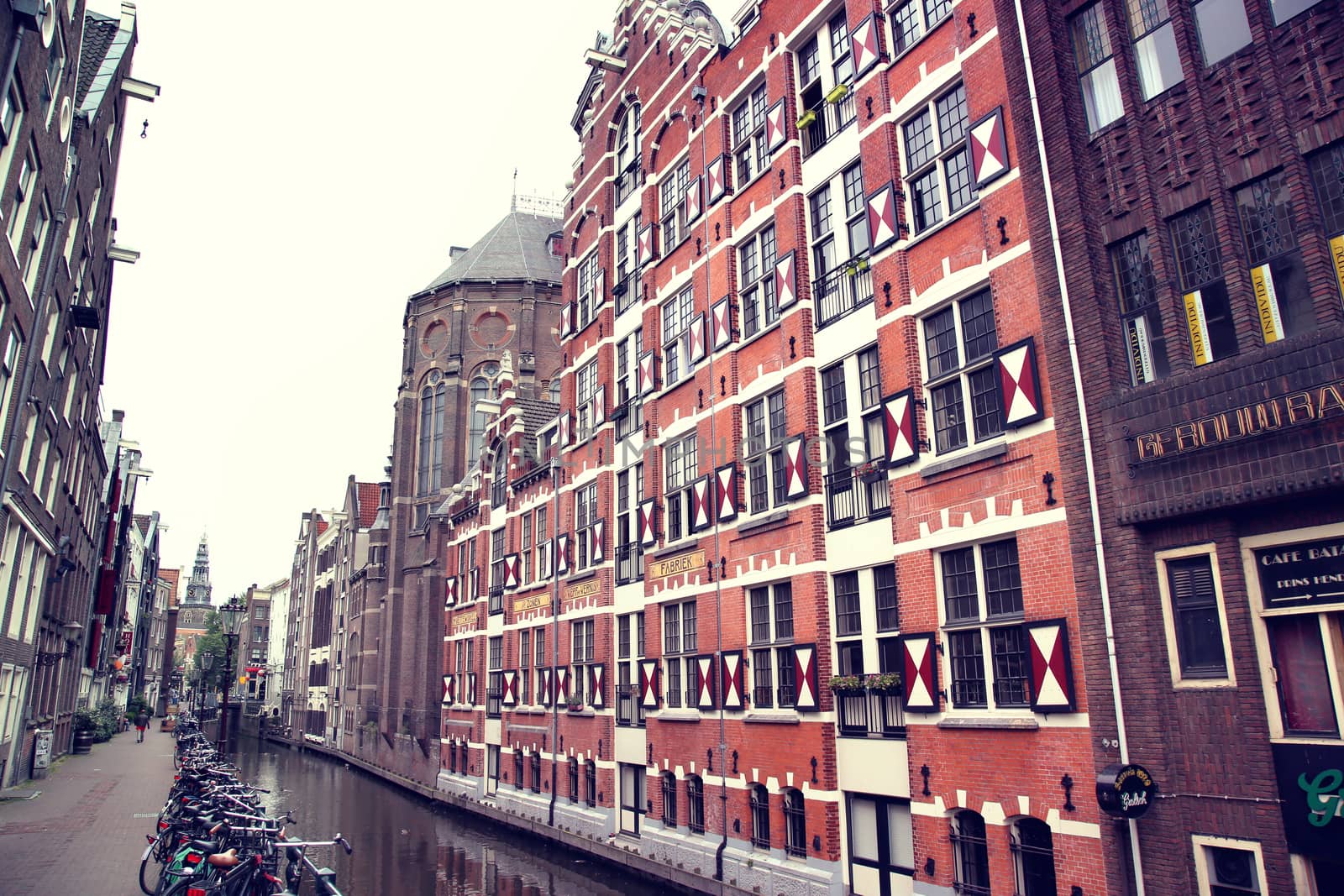 AMSTERDAM; THE NETHERLANDS - AUGUST 16; 2015: View on Oudezijds Kolk canal in Amsterdam, building Verf en Vernis Fabriek H.Vettewinke in Amsterdam. Amsterdam is capital of the Netherlands on August 16; 2015.