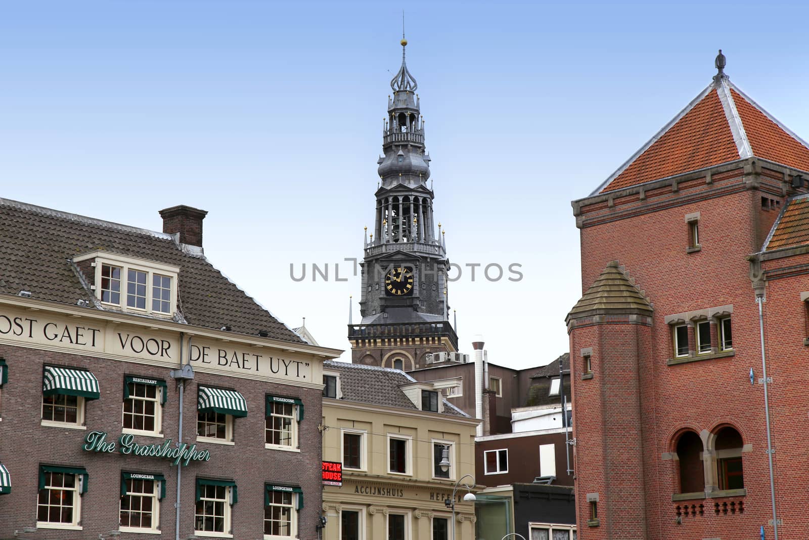 AMSTERDAM; THE NETHERLANDS - AUGUST 16; 2015: View of Oude Kerk (Old Church) from Damrak canal. Amsterdam is capital of the Netherlands on August 16; 2015.