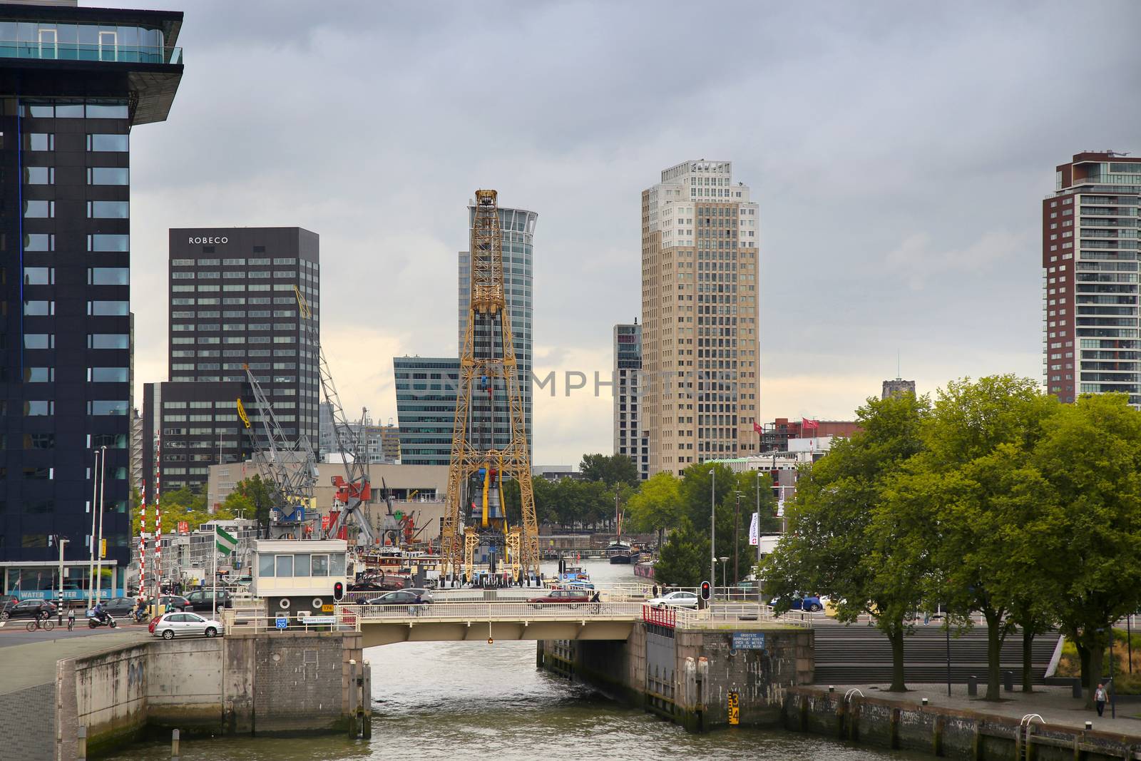 ROTTERDAM, THE NETHERLANDS - 18 AUGUST: Old cranes in Historical Leuvehaven, Rotterdam's oldest sea port. Harbor and modern apartment buildings in Rotterdam, Netherlands on August 18,2015.