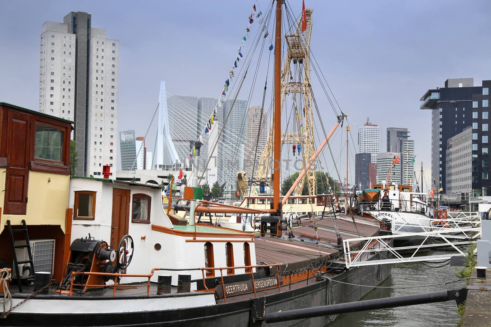 ROTTERDAM, THE NETHERLANDS - 18 AUGUST: Old cranes in Historical Leuvehaven, Rotterdam's oldest sea port. Harbor and modern apartment buildings in Rotterdam, Netherlands on August 18,2015.