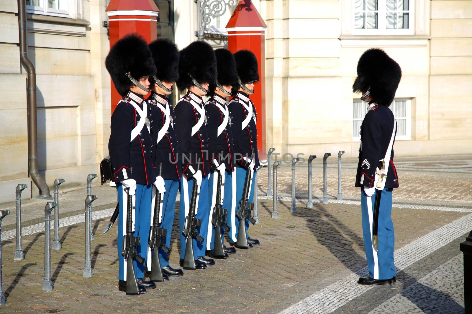 COPENHAGEN, DENMARK - AUGUST 15, 2016: Danish Royal Life Guards on the central plaza of Amalienborg palace, home of the Danish Royal family in Copenhagen, Denmark on August 15, 2016.