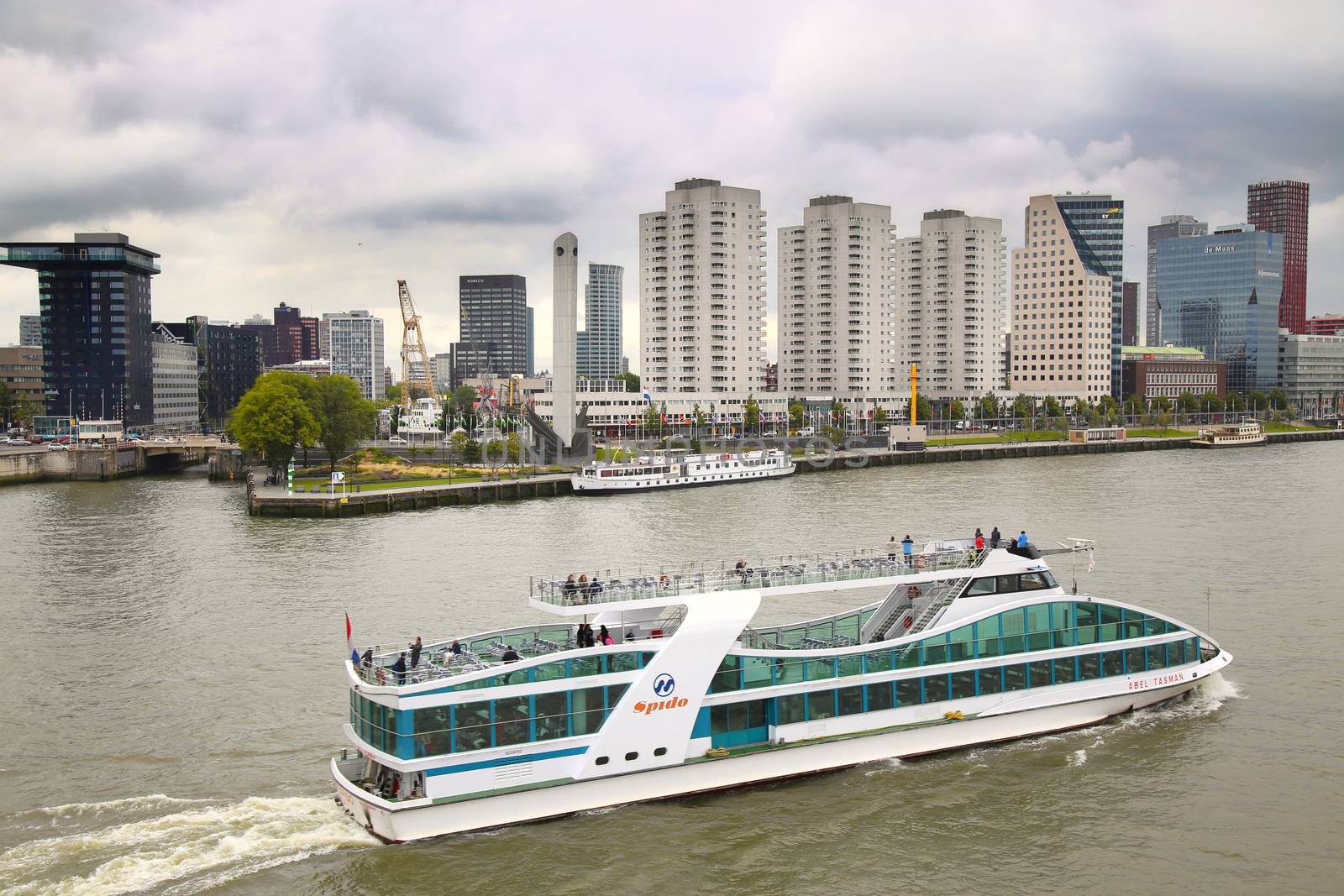 ROTTERDAM, THE NETHERLANDS - 18 AUGUST: View from Erasmus bridge on skyline of Rotterdam with a cruise boat, river Maas in Rotterdam, Netherlands on August 18,2015.