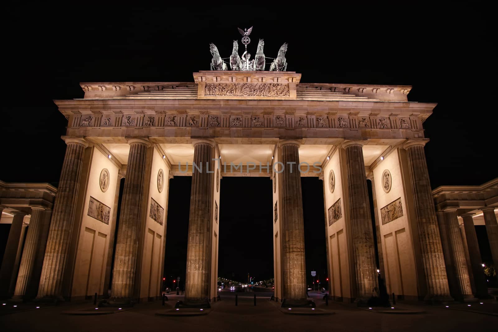 Brandenburg gate at night in Berlin, Germany by vladacanon
