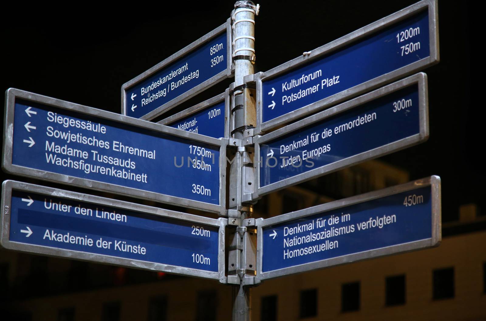 Road signs or street signs at Brandenburg gate in Berlin, German by vladacanon