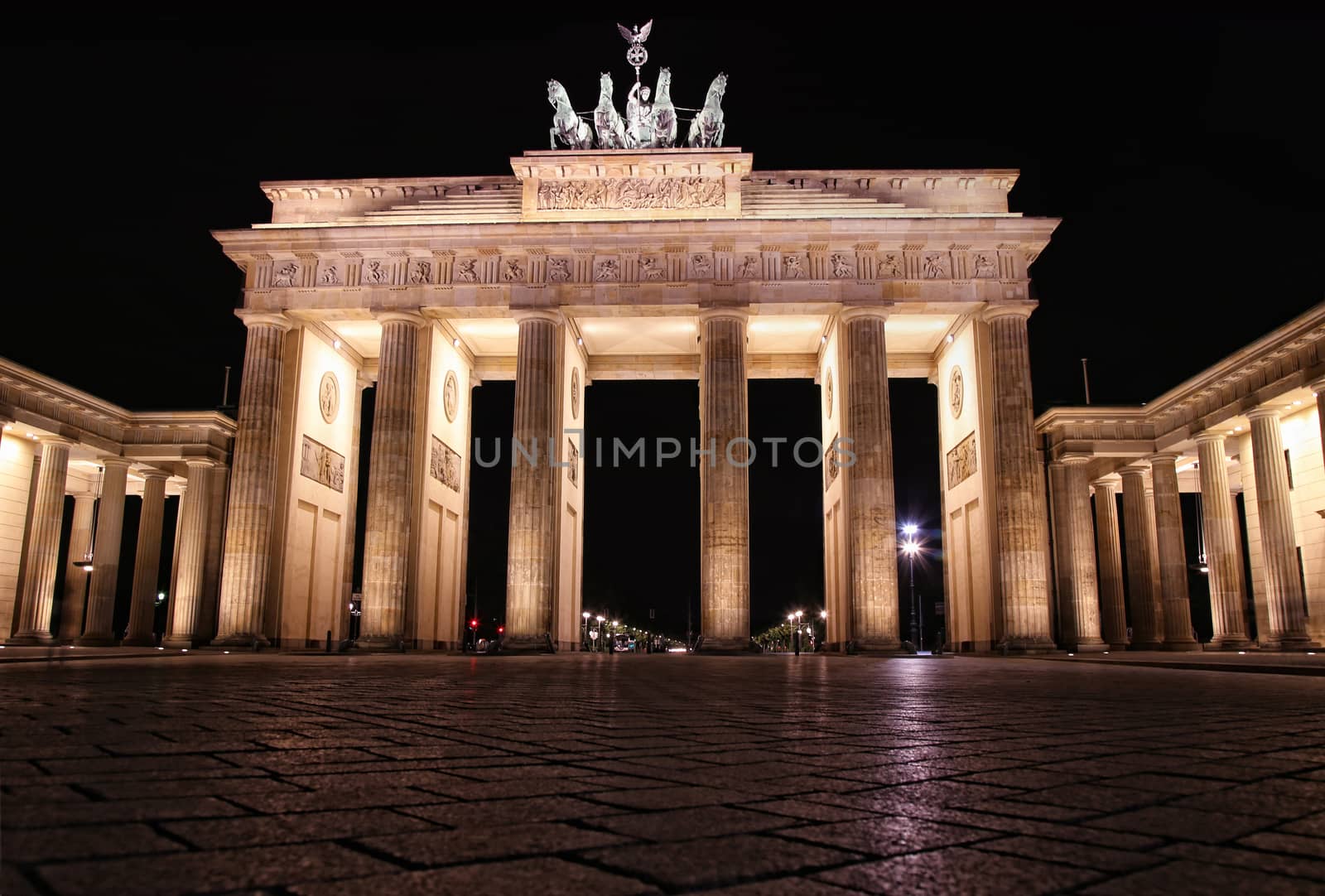 Brandenburg gate at night in Berlin, Germany by vladacanon