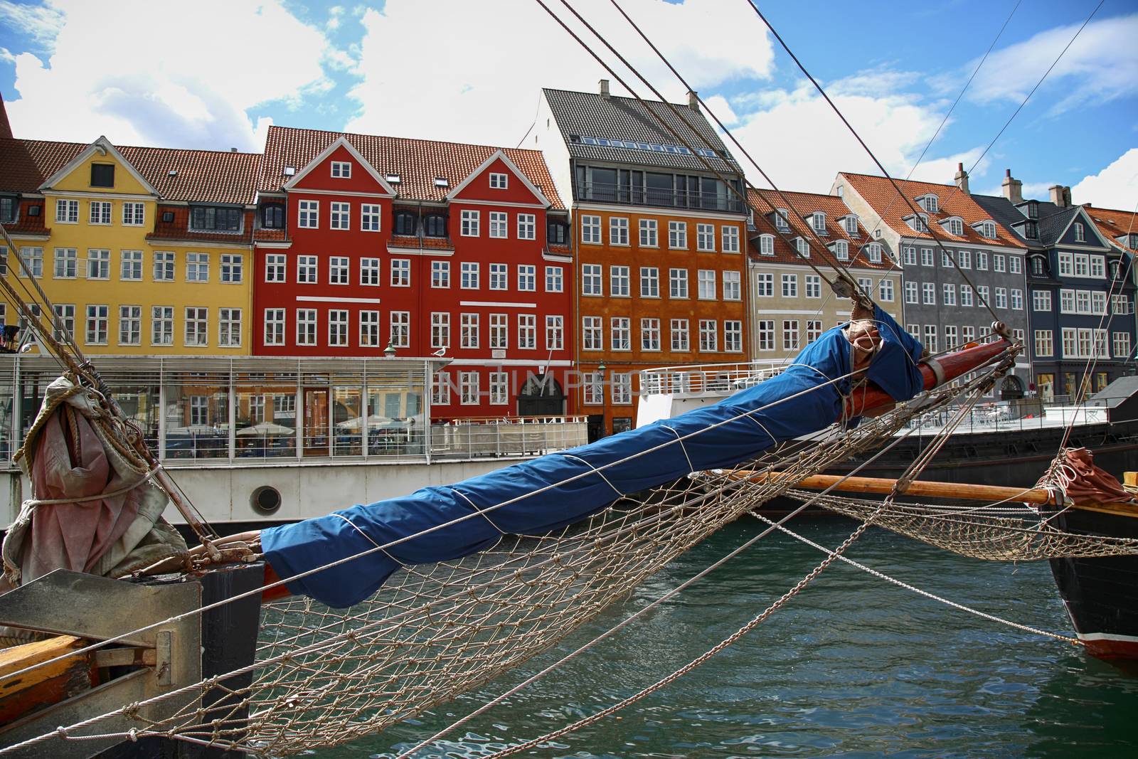 Yacht and color houses in seafront Nyhavn (new Harbor) in Copenhagen, Denmark