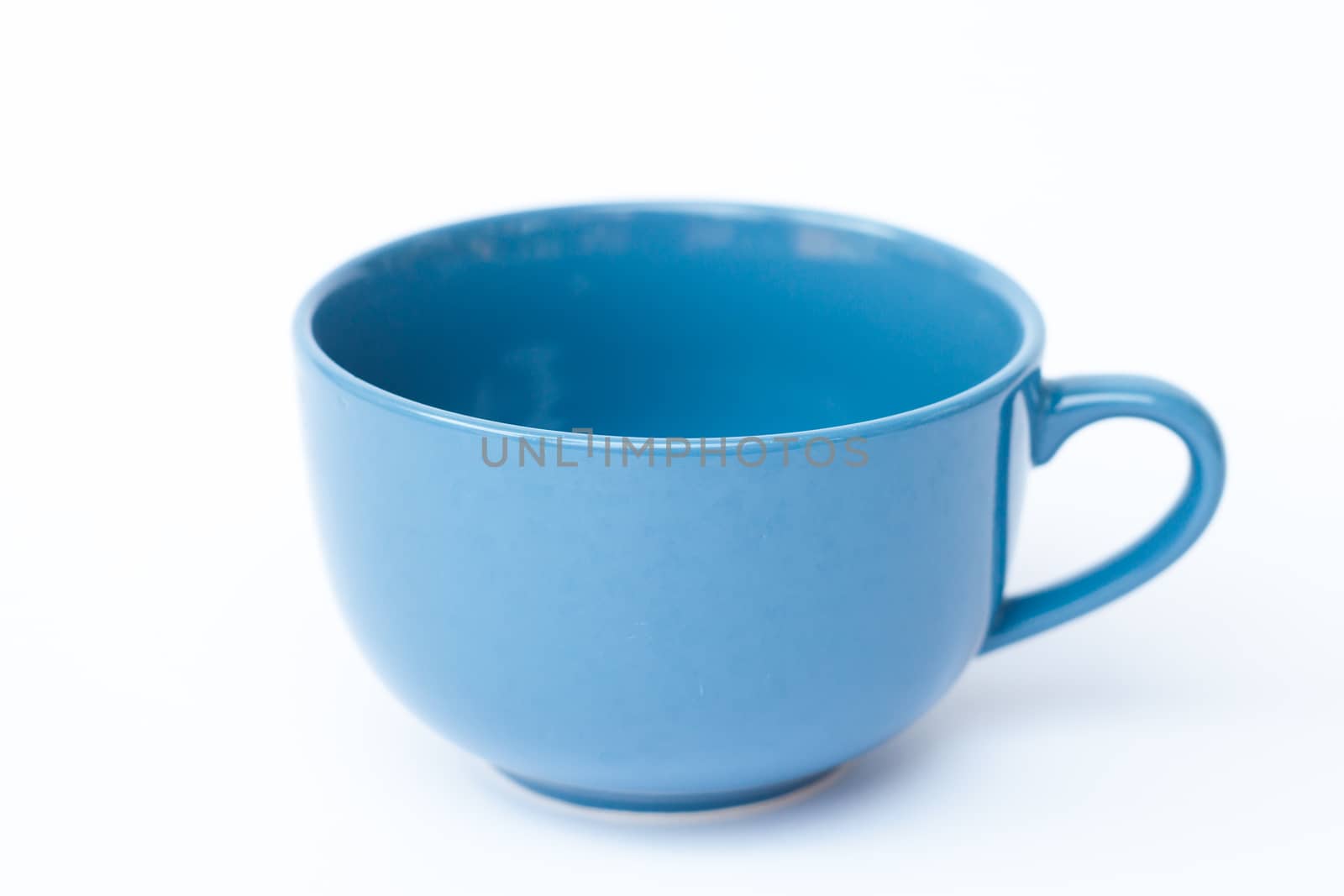 Blue ceramic bowl on white background, stock photo