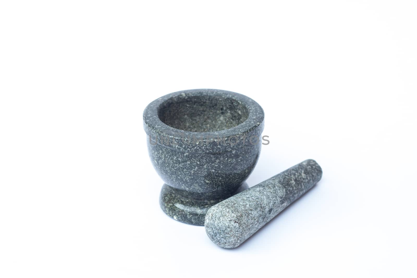 Stone mortar and pestle on white background, stock photo