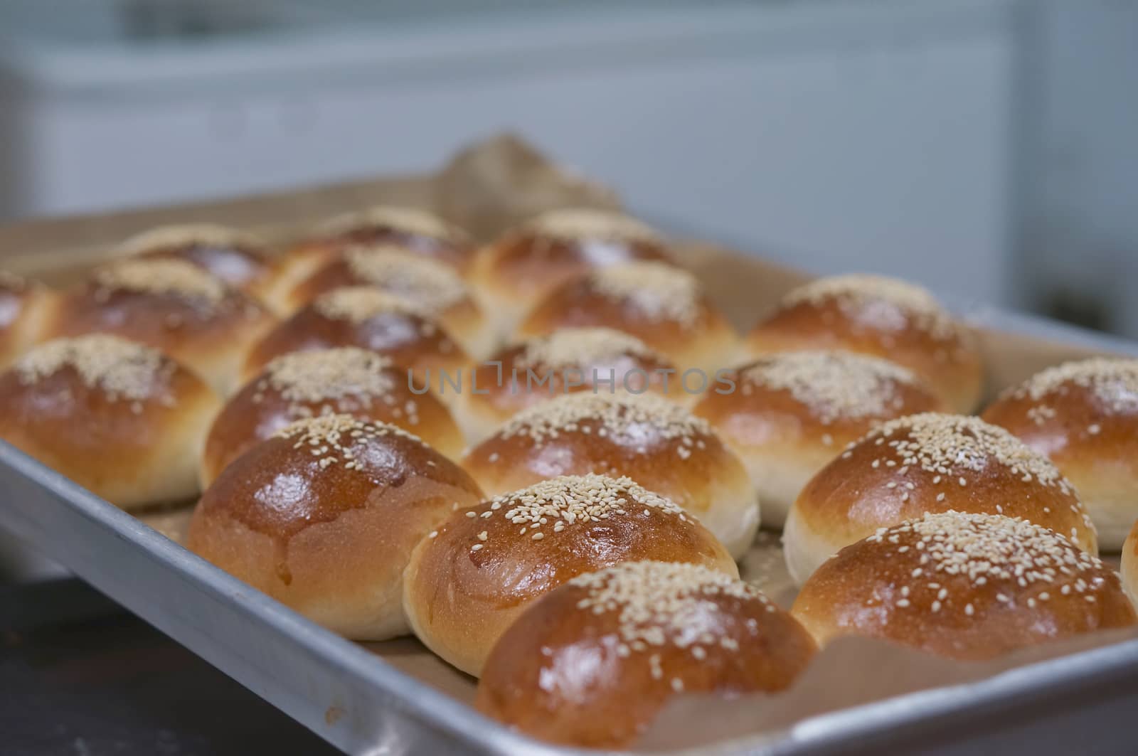 Dessert bread on top with sesame on stainless tray in kitchens.