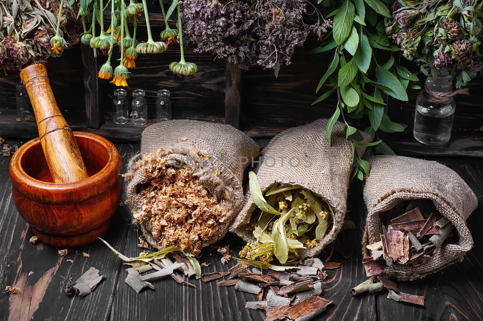 Three bags with dry herbs in a dark key